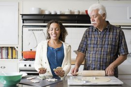 A father and daughter making cookies