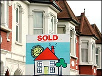 A house with a sold sign outside