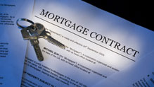 House keys on top of mortgage contract
