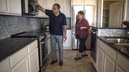 Prospective home buyers view a kitchen while touring a model home at a PulteGroup housing development in Albuquerque, New Mexico.