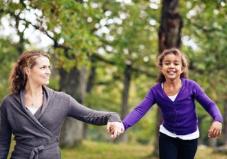 Saving for education as shown by a mom holding daughter's hand